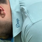 Close detail of the tonal Deep script embroidered at the collar